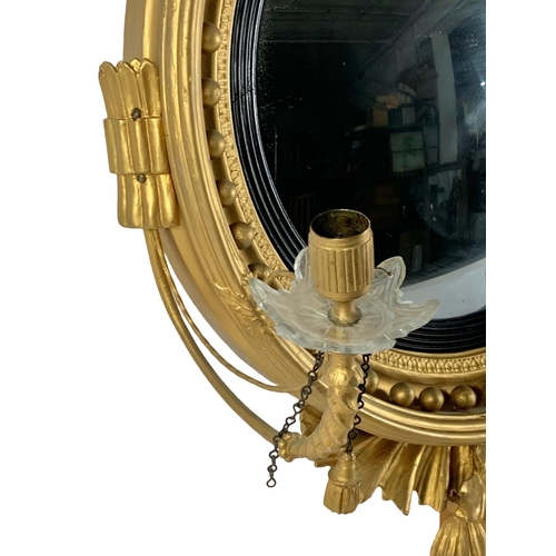 802a - A Thomas Fentham Regency gilt framed convex mirror. Circa 1810-1815. 59 x 90cm