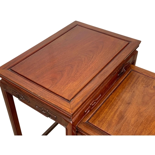 811 - A Chinese teak nest of 4 tables. 50.5 x 35.5 x 68.5cm