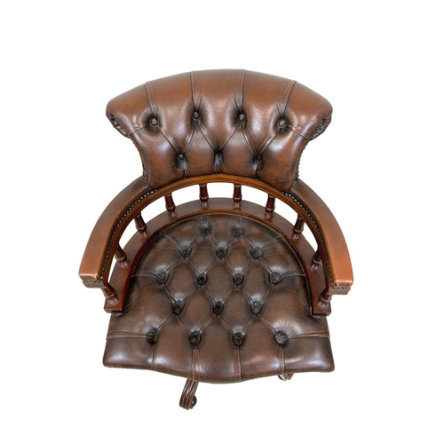 816 - A deep button brown leather swivel captains desk chair.