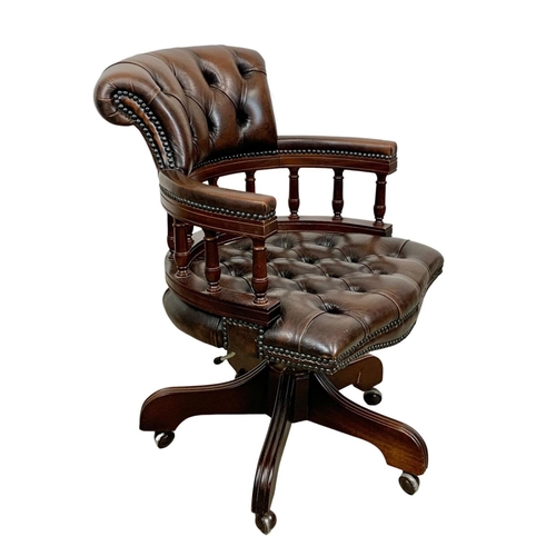 816 - A deep button brown leather swivel captains desk chair.