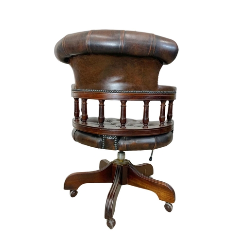 816 - A deep button brown leather swivel captains desk chair.