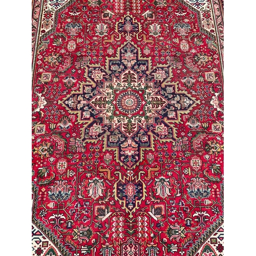 823 - A very large vintage Persian Tabriz hand knotted rug. 248.5 x 344cm.