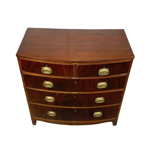 832 - A Georgian brass inlaid mahogany bow front chest of drawers. Circa 1820. 90 x 50 x 90.5cm