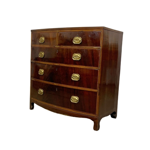 832 - A Georgian brass inlaid mahogany bow front chest of drawers. Circa 1820. 90 x 50 x 90.5cm