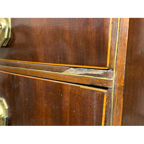 832 - A Georgian brass inlaid mahogany bow front chest of drawers. Circa 1820. 90 x 50 x 90.5cm