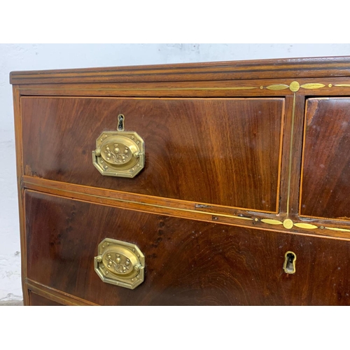 832 - A Georgian brass inlaid mahogany bow front chest of drawers. Circa 1820. 90 x 50 x 90.5cm