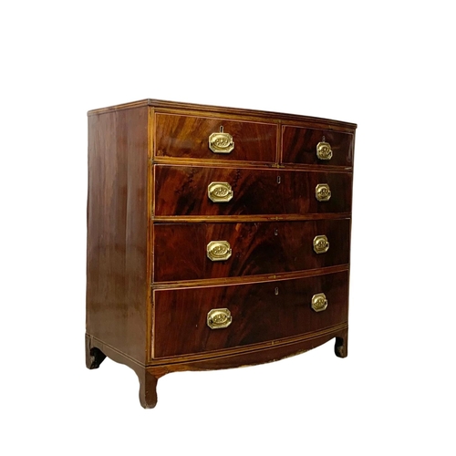 832 - A Georgian brass inlaid mahogany bow front chest of drawers. Circa 1820. 90 x 50 x 90.5cm