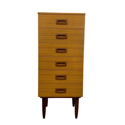 836 - A tall teak and formica Mid Century chest of drawers. 50 x 45 x 118.5cm