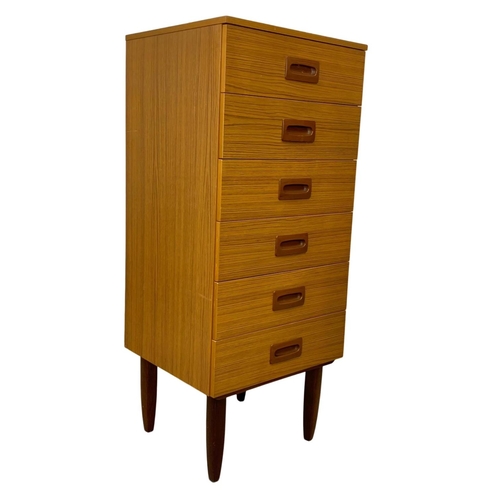 836 - A tall teak and formica Mid Century chest of drawers. 50 x 45 x 118.5cm