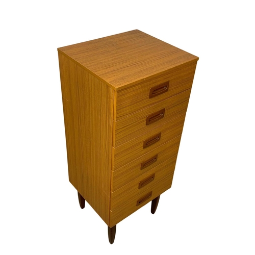 836 - A tall teak and formica Mid Century chest of drawers. 50 x 45 x 118.5cm