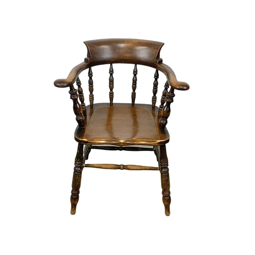 837 - A Victorian elm armchair.