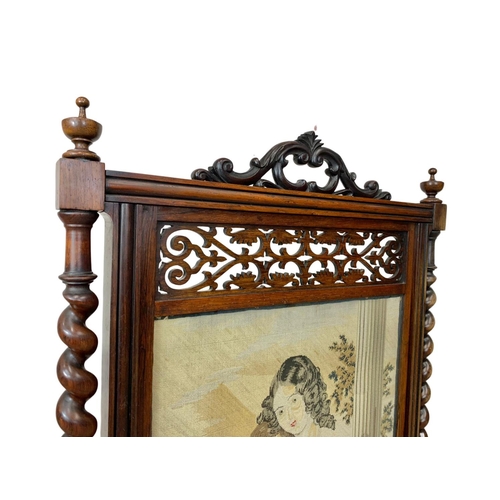 858 - A large Victorian carved rosewood fire screen. 57 x 109.5cm