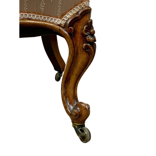 859 - A Victorian carved rosewood nursing chair on cabriole legs. Circa 1870. 52 x 74 x 98cm