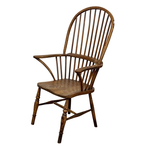 868 - A large mid 19th century elm Windsor armchair.