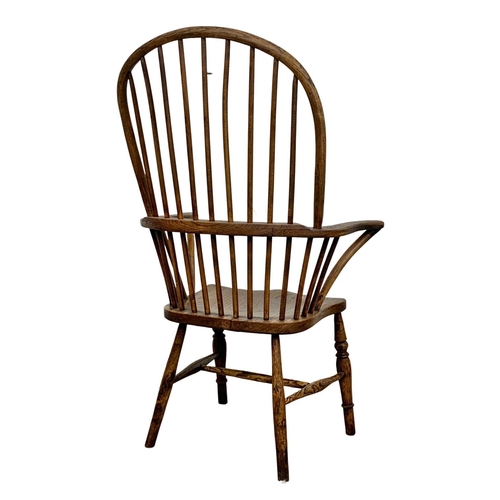 868 - A large mid 19th century elm Windsor armchair.