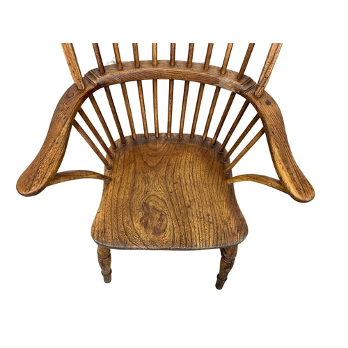 868 - A large mid 19th century elm Windsor armchair.