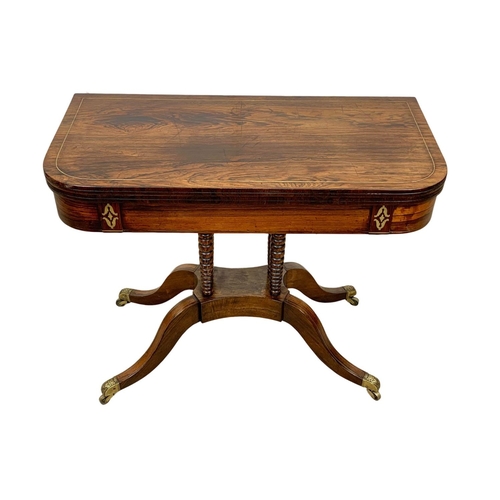 869 - A Regency brass inlaid rosewood turnover games table. Circa 1820. 93.5 x 46 x 77cm