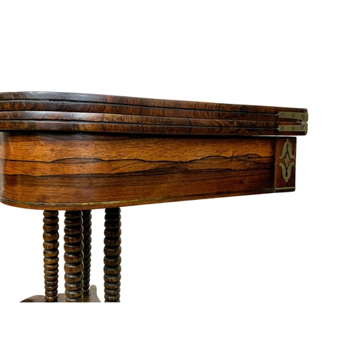 869 - A Regency brass inlaid rosewood turnover games table. Circa 1820. 93.5 x 46 x 77cm