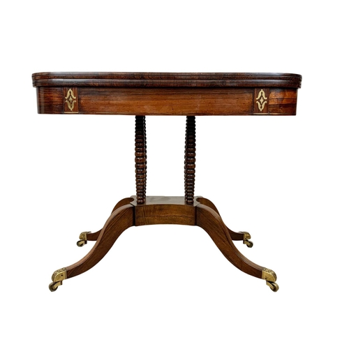 869 - A Regency brass inlaid rosewood turnover games table. Circa 1820. 93.5 x 46 x 77cm