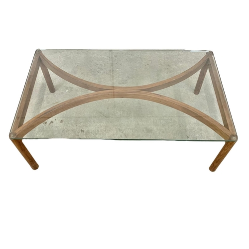 870 - A Danish teak framed glass top coffee table. Mid Century. 1960’s. 111 x 65 36.5cm