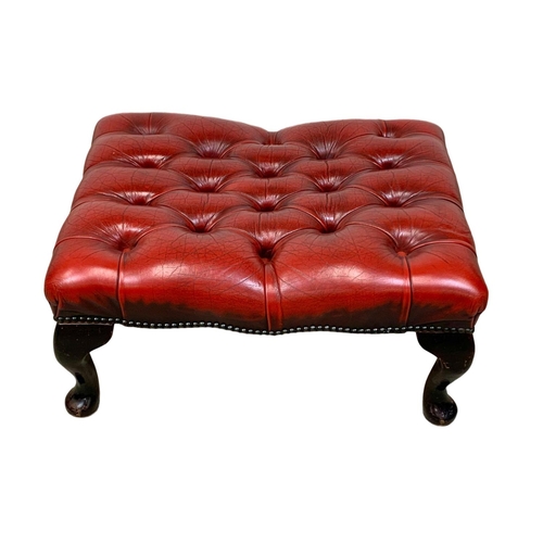 935 - A deep button ox-blood leather footstool. 66 x 50 x 30cm