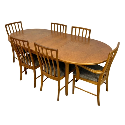 940 - A McIntosh teak extending dining table and 6 chairs. Mid Century. 1970. Extended 203 x 98 x 77cm. Cl... 