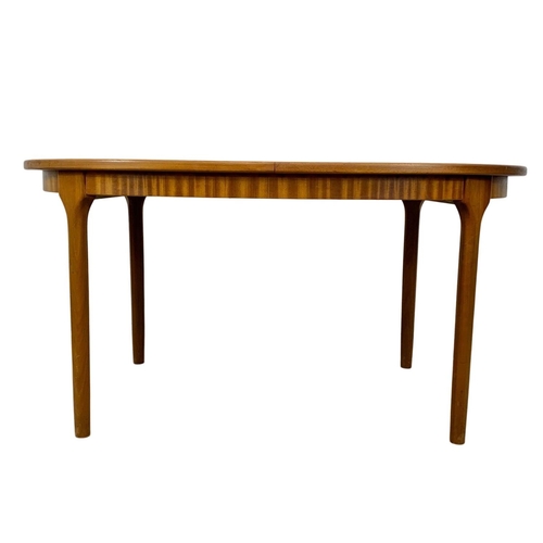 940 - A McIntosh teak extending dining table and 6 chairs. Mid Century. 1970. Extended 203 x 98 x 77cm. Cl... 