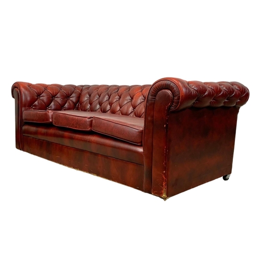 946 - An ox-blood leather button back 3 seater sofa. 191cm.