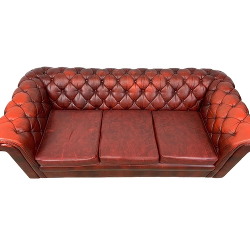 946 - An ox-blood leather button back 3 seater sofa. 191cm.