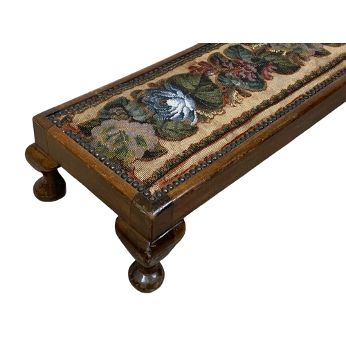 956 - A long early 20th century mahogany footstool with beadwork top. Circa 1920. 124 x 27 x 15cm