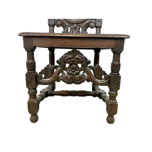 981 - A Victorian carved oak high back hall chair. Circa 1880. 130cm.