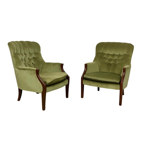 985 - A pair of vintage Parker Knoll model 1022-7 button back armchairs.