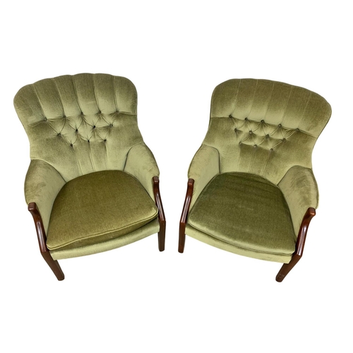 985 - A pair of vintage Parker Knoll model 1022-7 button back armchairs.