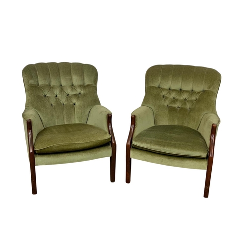 985 - A pair of vintage Parker Knoll model 1022-7 button back armchairs.