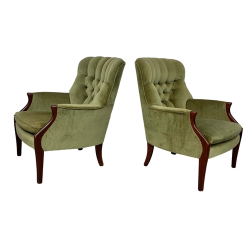 985 - A pair of vintage Parker Knoll model 1022-7 button back armchairs.