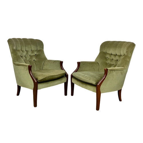 985 - A pair of vintage Parker Knoll model 1022-7 button back armchairs.