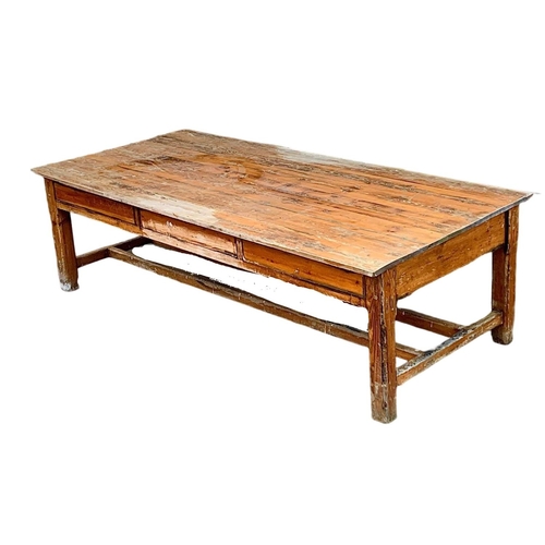 986 - A very large late 19th century pitch pine table. Possibly from old warehouse or mill.  Circa 1890. 2... 