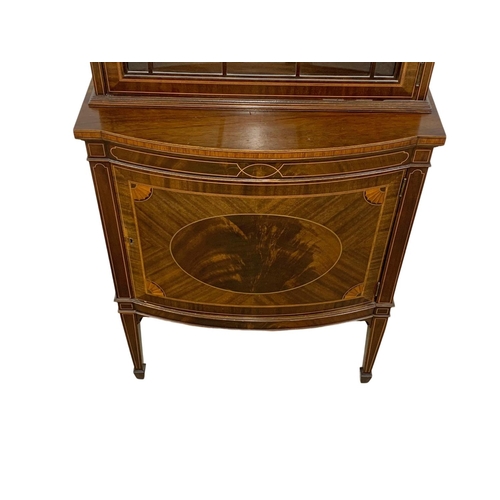 993 - A vintage inlaid mahogany display cabinet in the Sheraton and Federal style. 66 x 40 x 199cm.