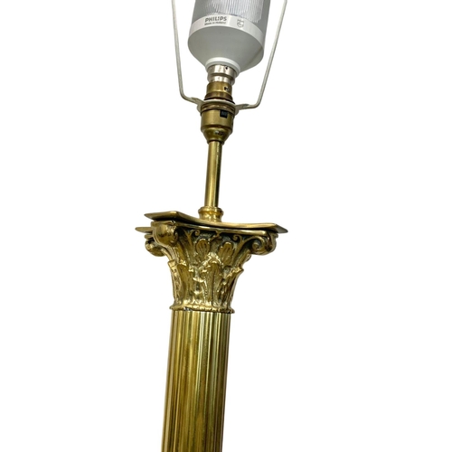 994 - A vintage brass standard lamp with Corinthian pillars. 168cm