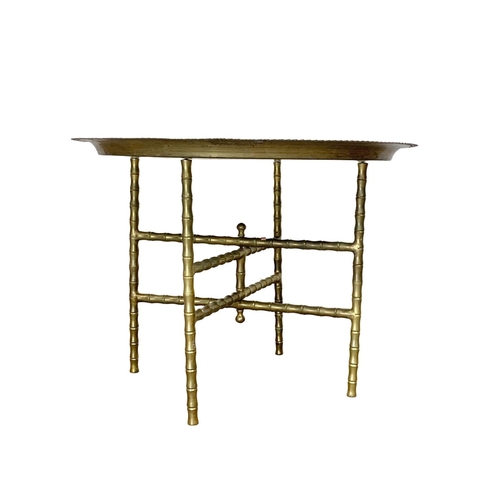 996 - A pair of early 20th century folding Middle Eastern brass tables. 59.5 x 44cm.