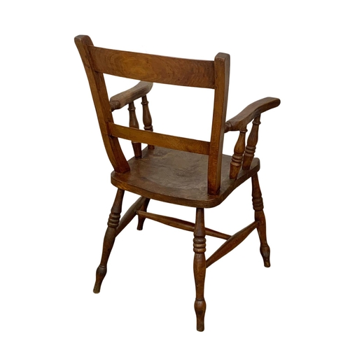 999 - A Victorian elm kitchen armchair.