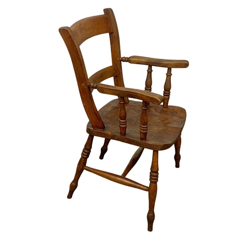 999 - A Victorian elm kitchen armchair.