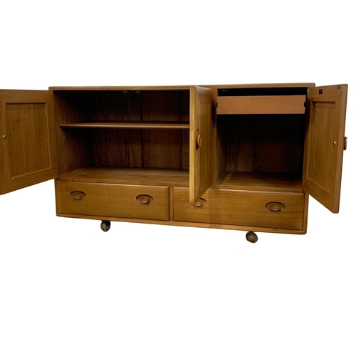 887 - An Ercol Blonde elm Mid Century sideboard. 130 x 44 x 76cm.