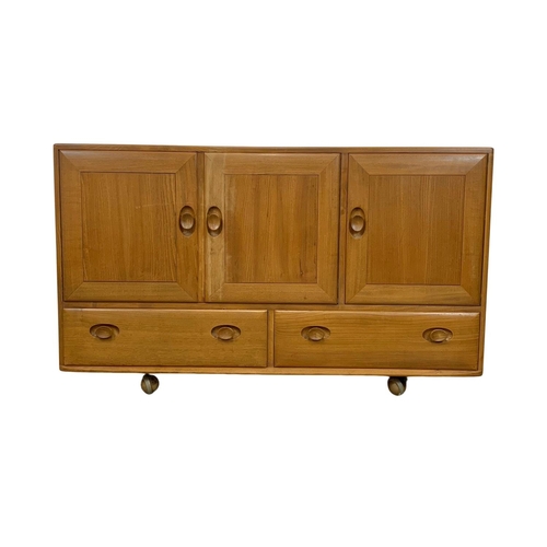 887 - An Ercol Blonde elm Mid Century sideboard. 130 x 44 x 76cm.