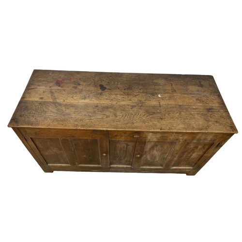 1091 - An 18th century oak meal bin converted to cupboard. 157 x 61 x 83cm.