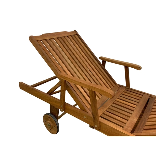 1105 - A large wooden sun lounger. 224cm.