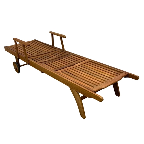 1105 - A large wooden sun lounger. 224cm.