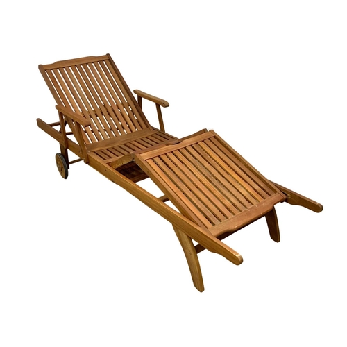 1106 - A large wooden sun lounger. 224cm.