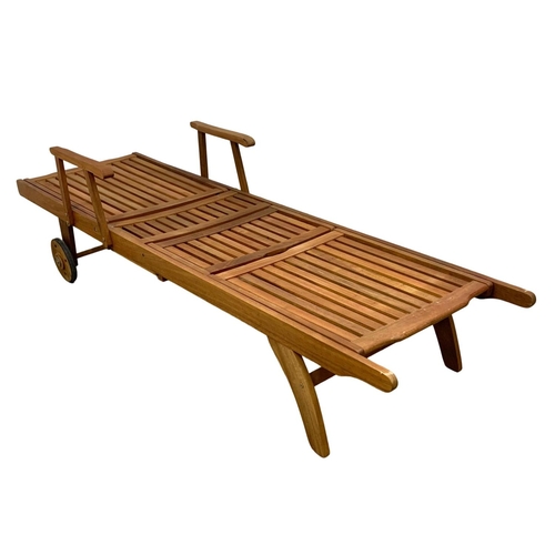 1106 - A large wooden sun lounger. 224cm.