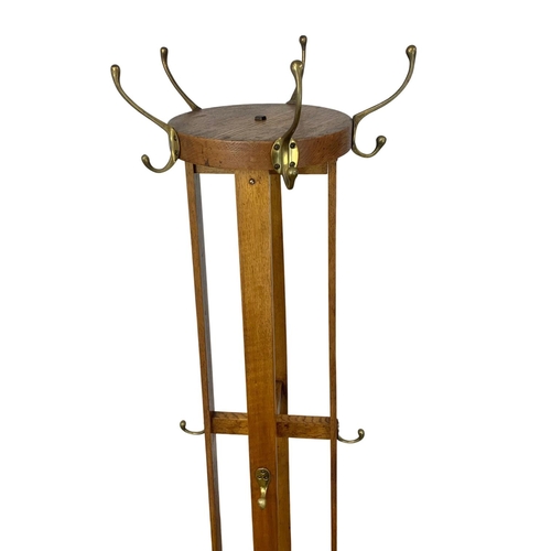 1150 - An early 20th century oak hat and coat stand with revolving top. 198cm.